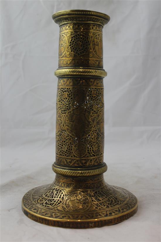 A 19th century Qajar Islamic pierced brass torch stand, 10.5in.